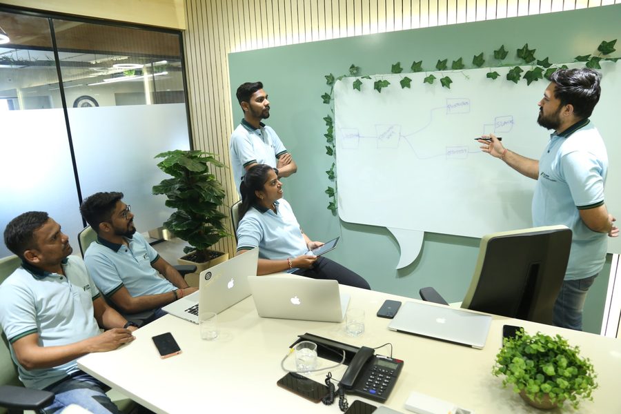 Hupp Technologies engineers working through a problem at the whiteboard